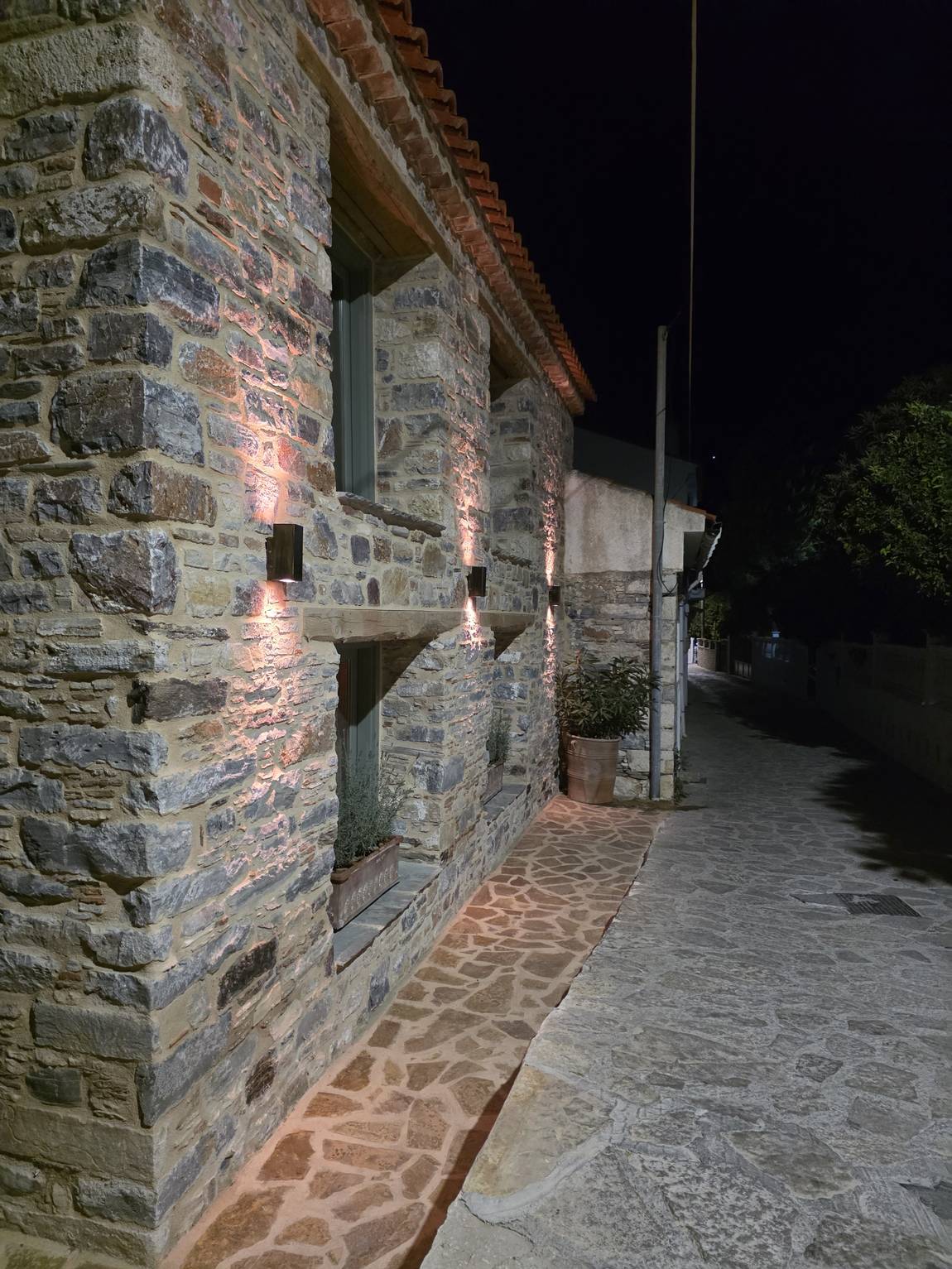 Wall lamps washing the masonry in copper light