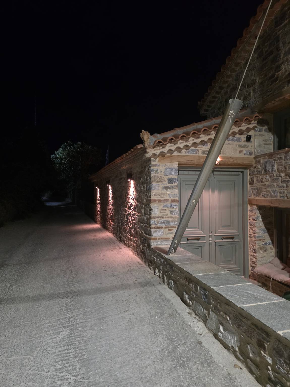 The street alongside the house, lit all the way to the door